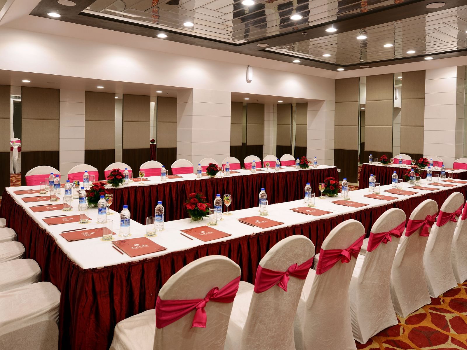 Board room seating arrangement with well-lit ambience and water bottles on the table