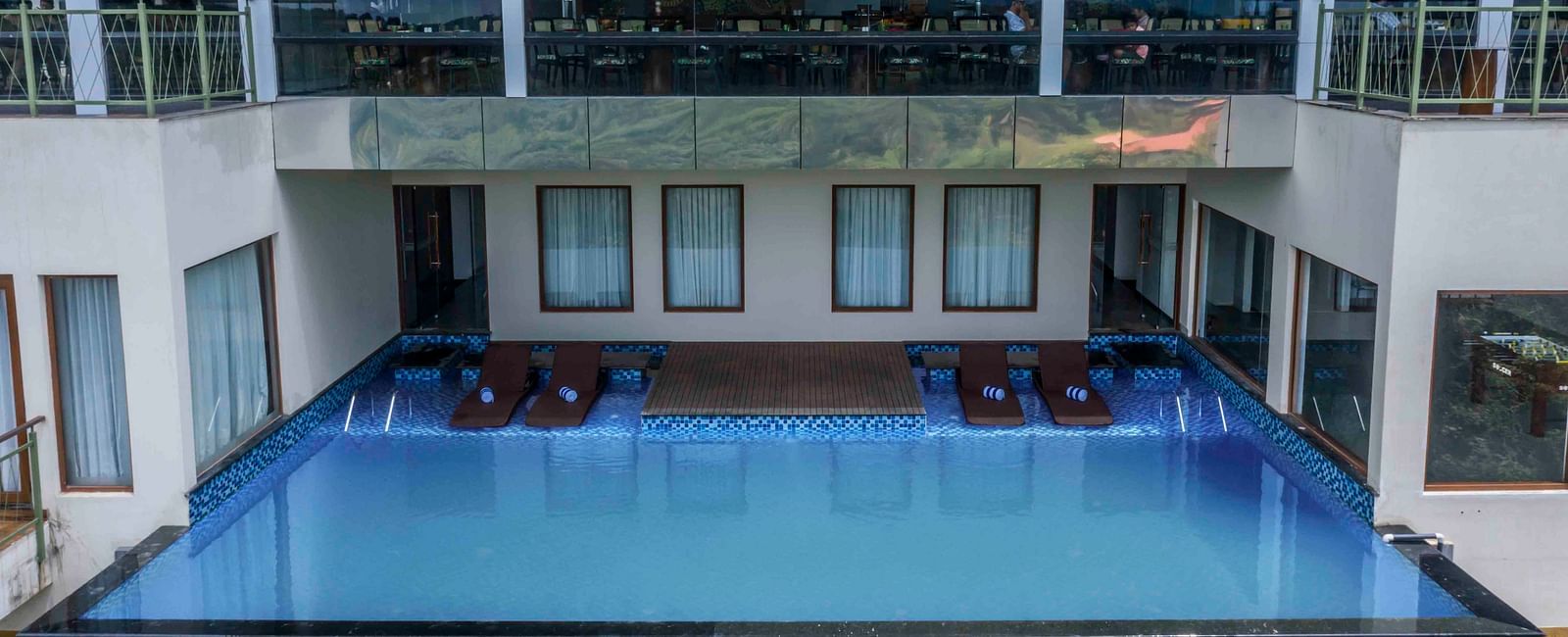 Image of  a swimming pool inside our hotel | Great Trails Wayanad by  GRT hotels.