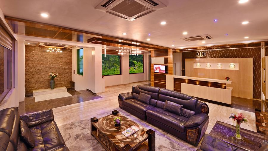 A view of a hotel lobby, at Lords Inn Porbandar, with plush seating, decorative elements, and warm lighting creating a comfortable space.