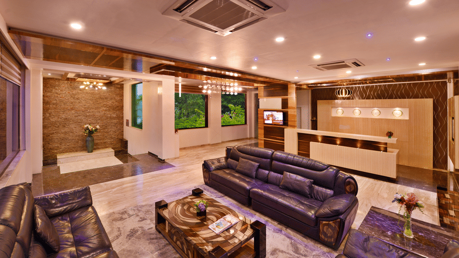 A view of a hotel lobby, at Lords Inn Porbandar, with plush seating, decorative elements, and warm lighting creating a comfortable space.