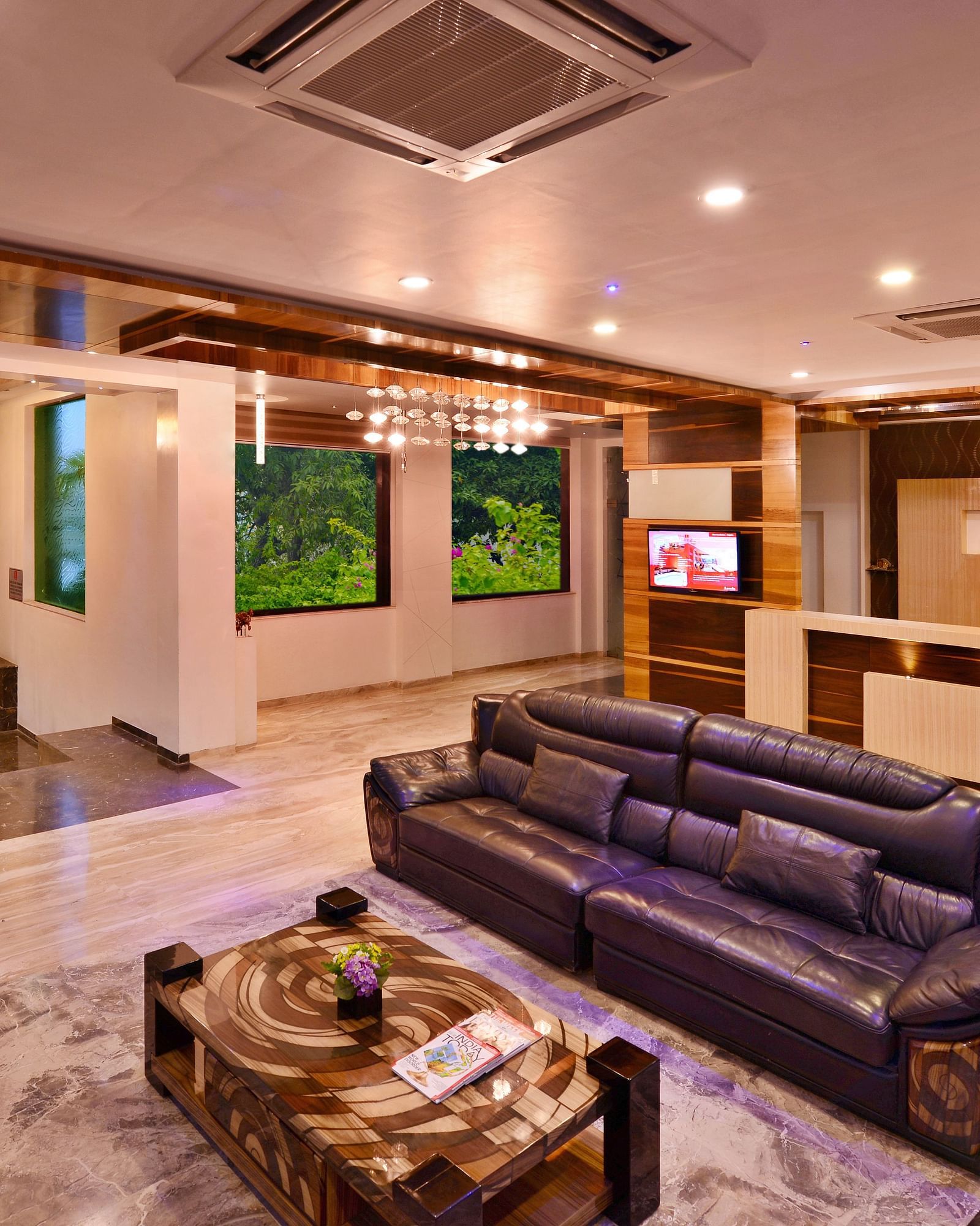 A view of a hotel lobby, at Lords Inn Porbandar, with plush seating, decorative elements, and warm lighting creating a comfortable space.