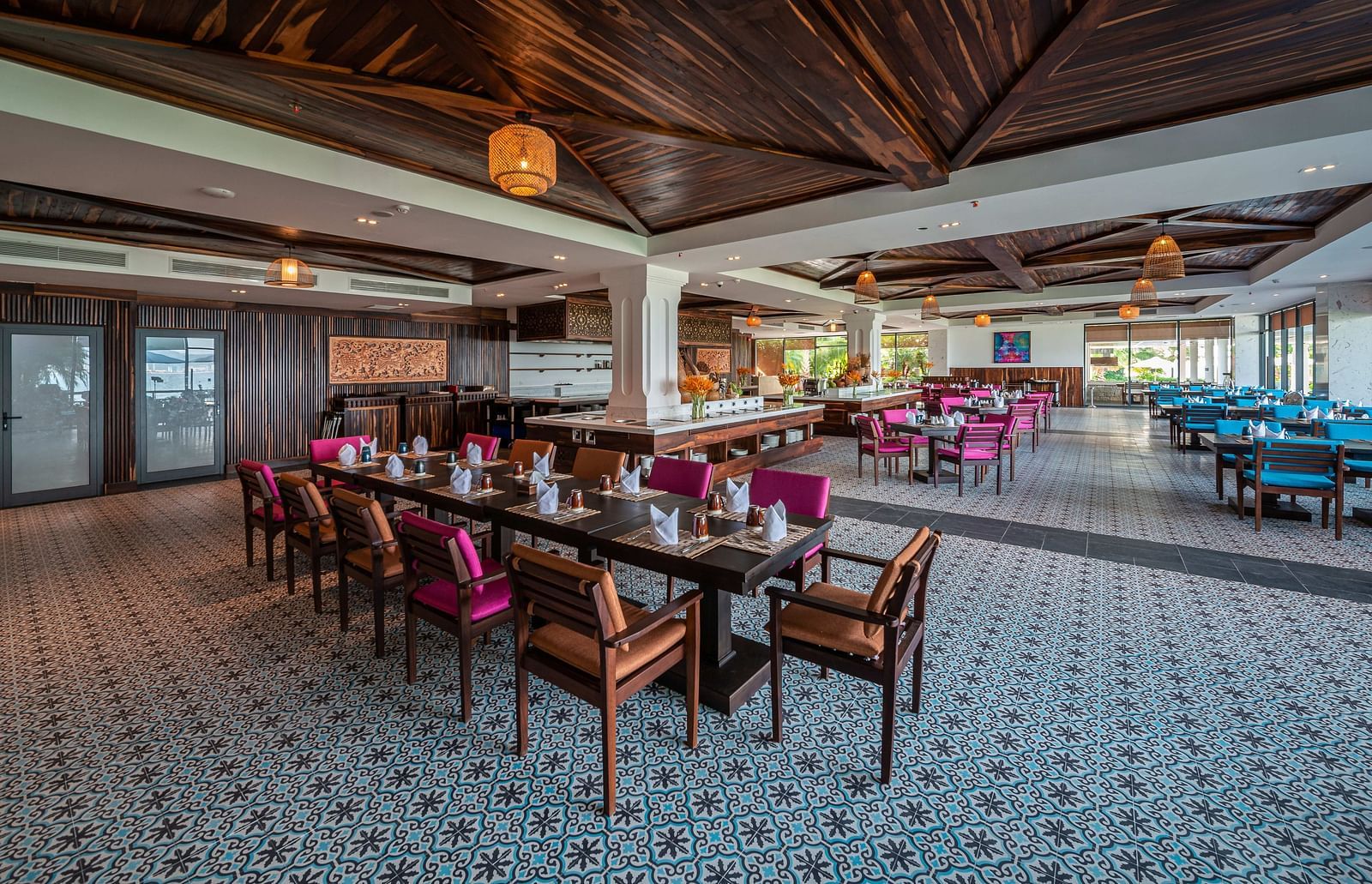 Another view of a long table seating arrangement in a restaurant with ambient lighting - Alibu Resort Nha Trang