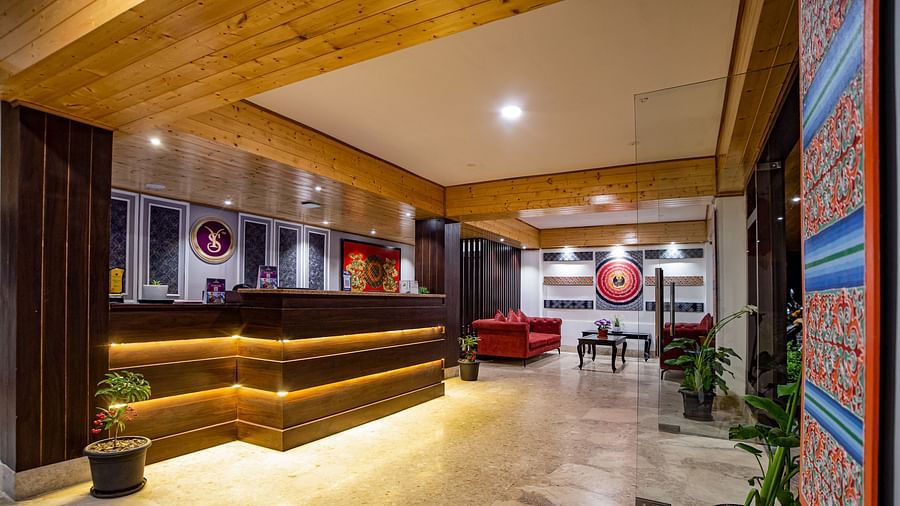 Side view of the  Sumitel Hotel's reception area showing more of the wooden interior, lighting, and surrounding decor