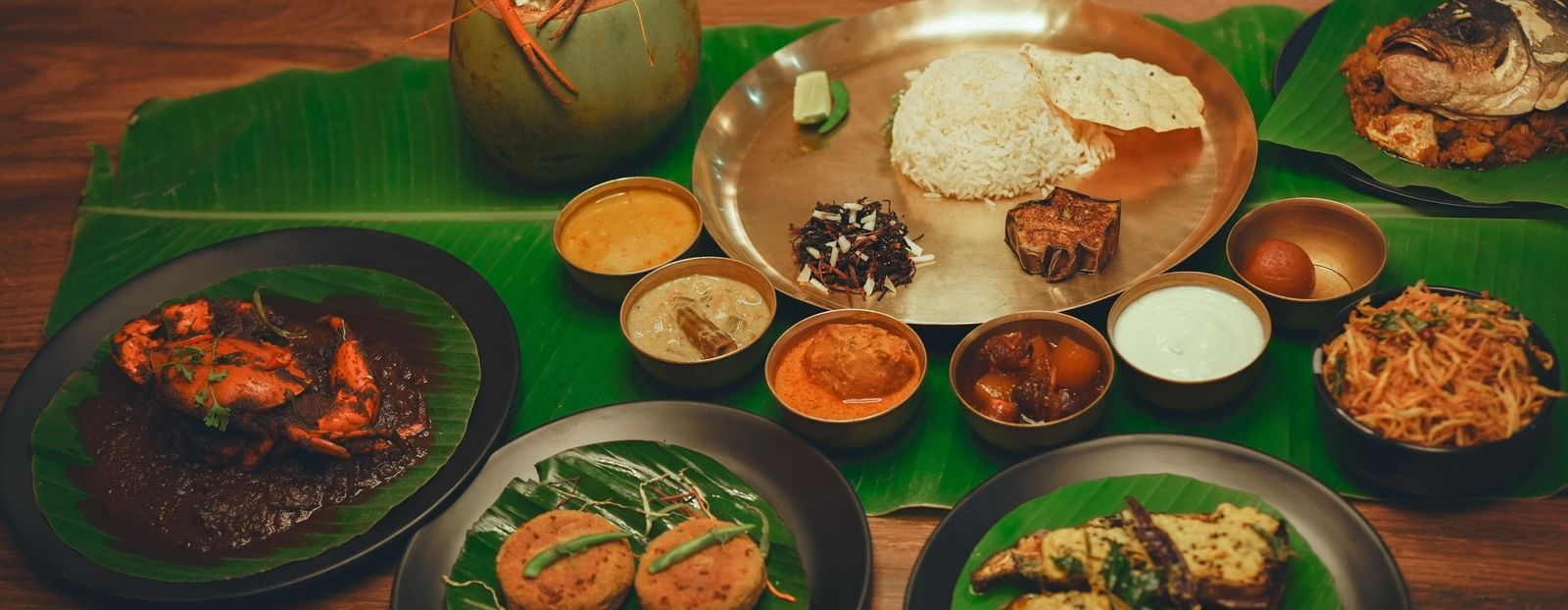 image featuring a bengali thali with several side dishes along with a huge spread of authentic bengali cuisine - Dip Holidays, Birbhum