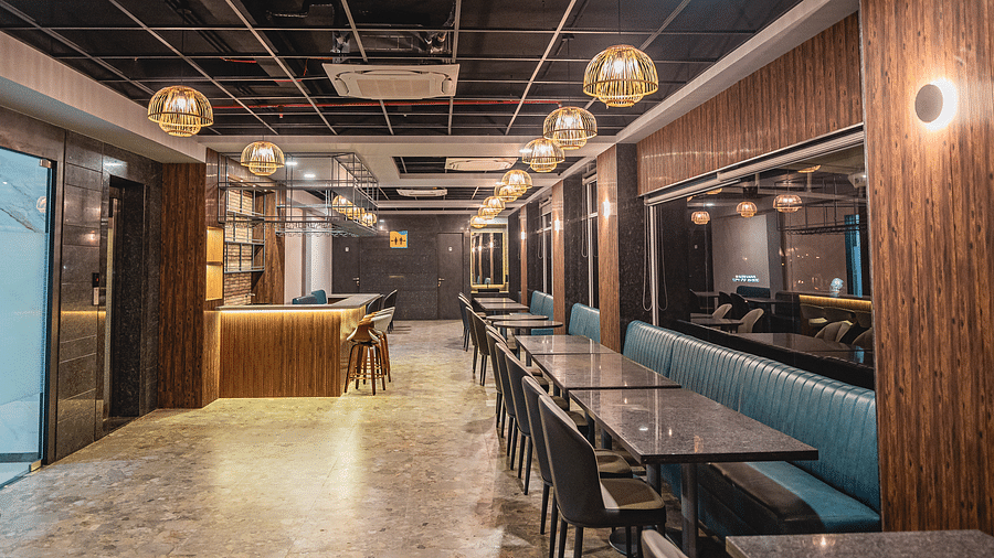 A chic dining space with a bar counter and spacious seating arrangements at Lotus Leaf Boutique Hotel.