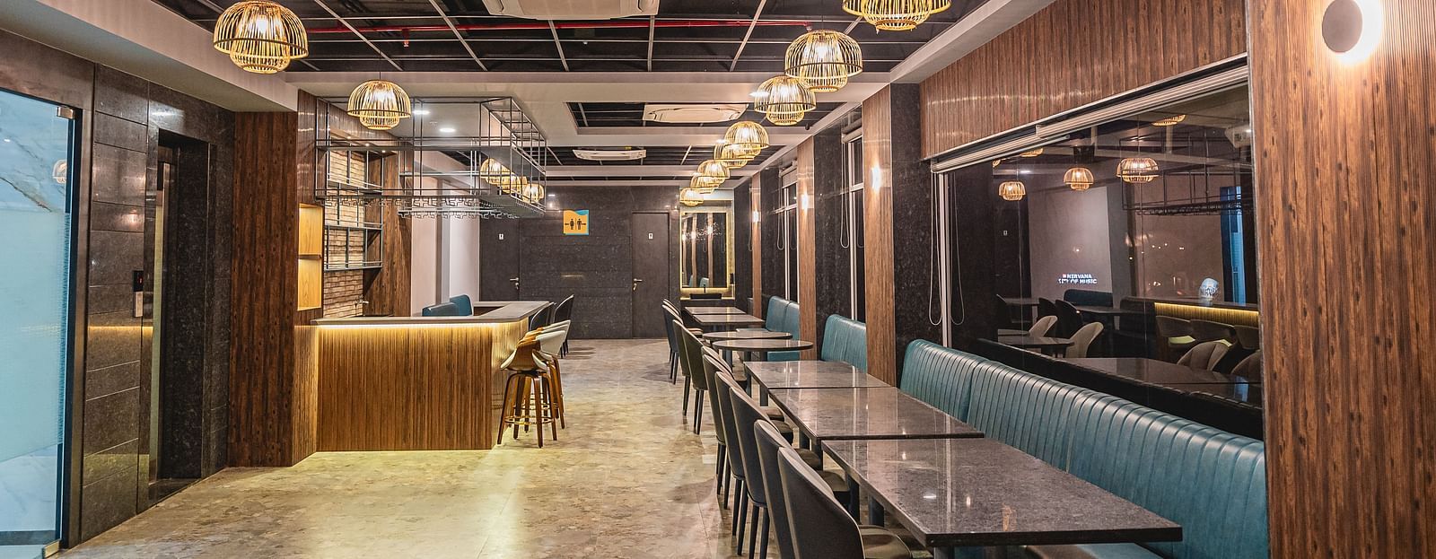 A full view of a well-lit restaurant with tables and chairs at Lotus Leaf Boutique Hotel
