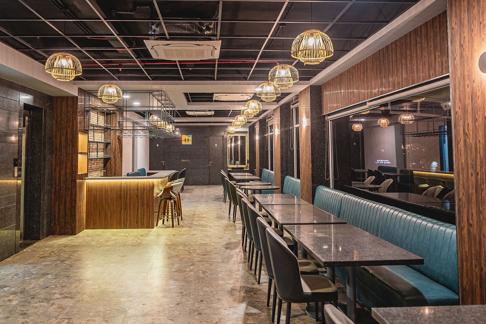 A full view of a well-lit restaurant with tables and chairs at Lotus Leaf Boutique Hotel