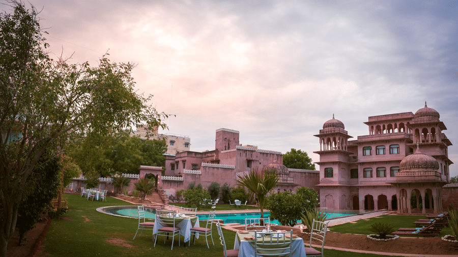 Facade interior with Pool and chairs and tables for sitting at Hotel Castle Mandawa, Jhunjunu