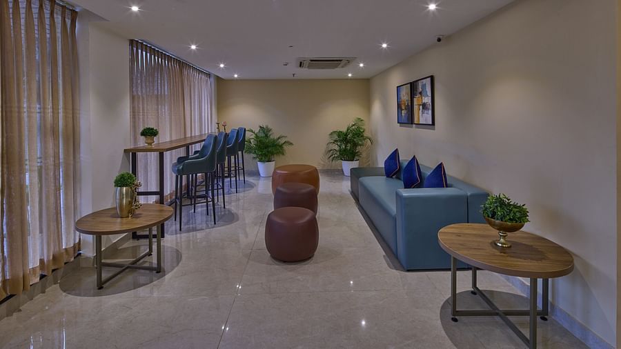 A lounge area with a comfortable seating and ambient lighting - Grand Continent, Brookefield