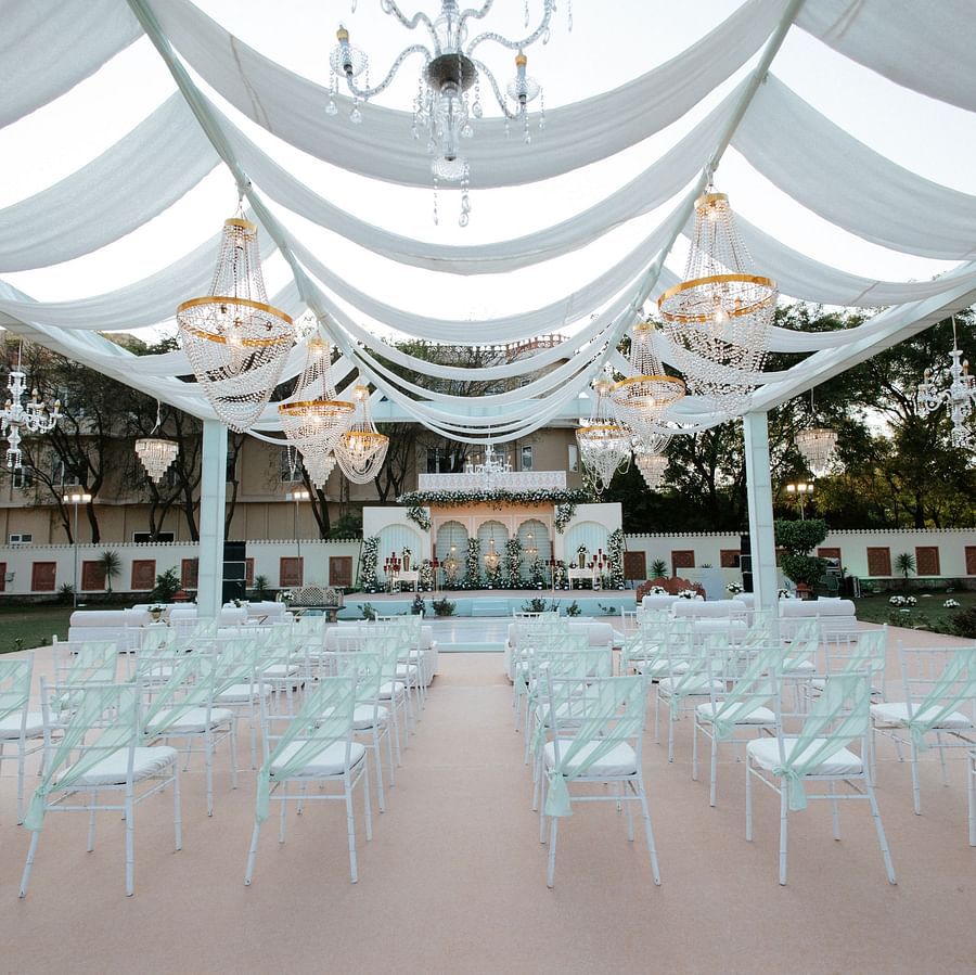 Open-air wedding seating setup under white canopy at Umaid palace.