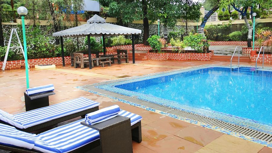 the sun-bathing beds kept by the pool at our resort - Zara's Resort 1