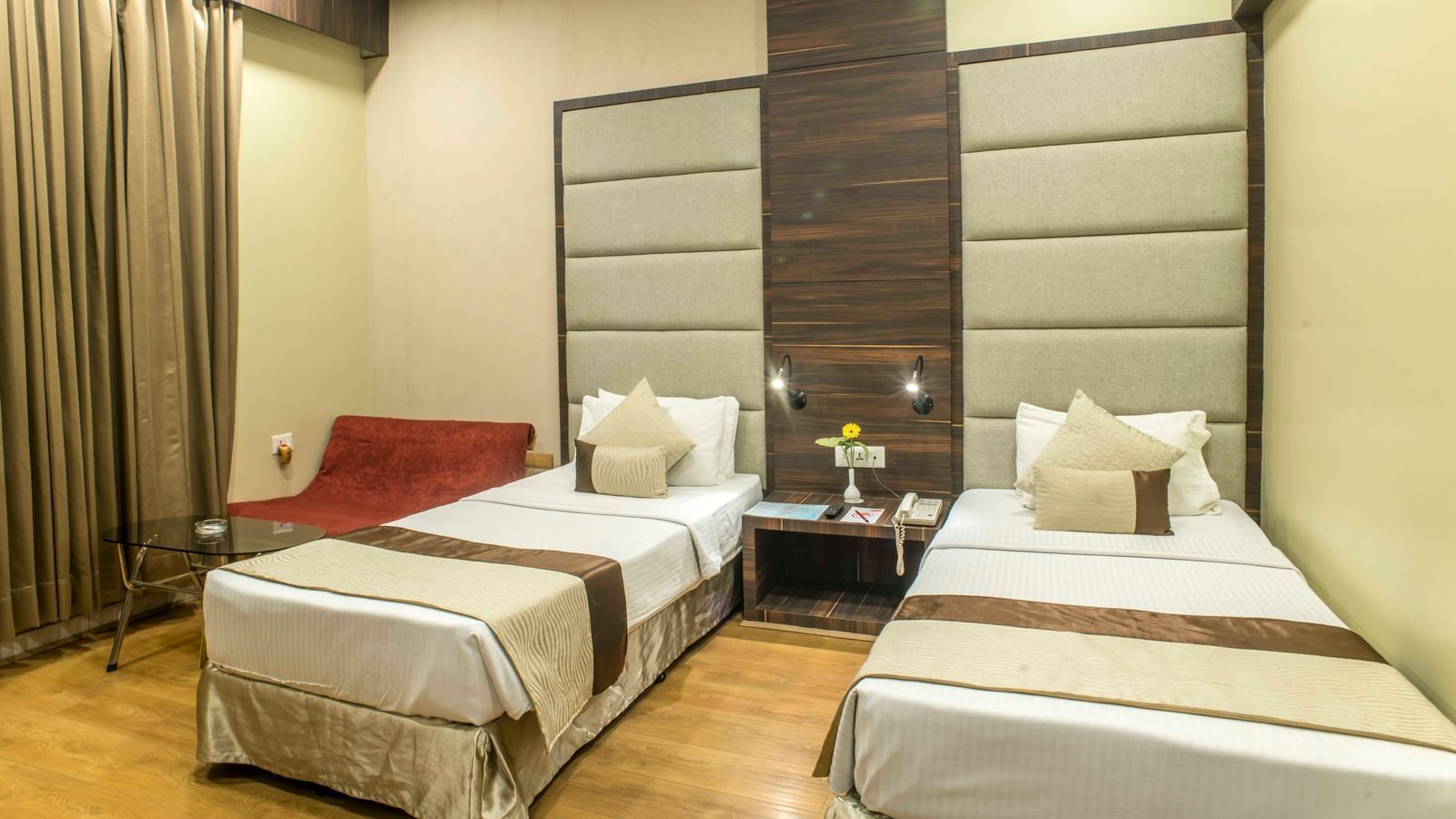 Comfortable hotel room with two single beds, warm lighting, and simple decor| The Citi Residenci Hotel Durgapur