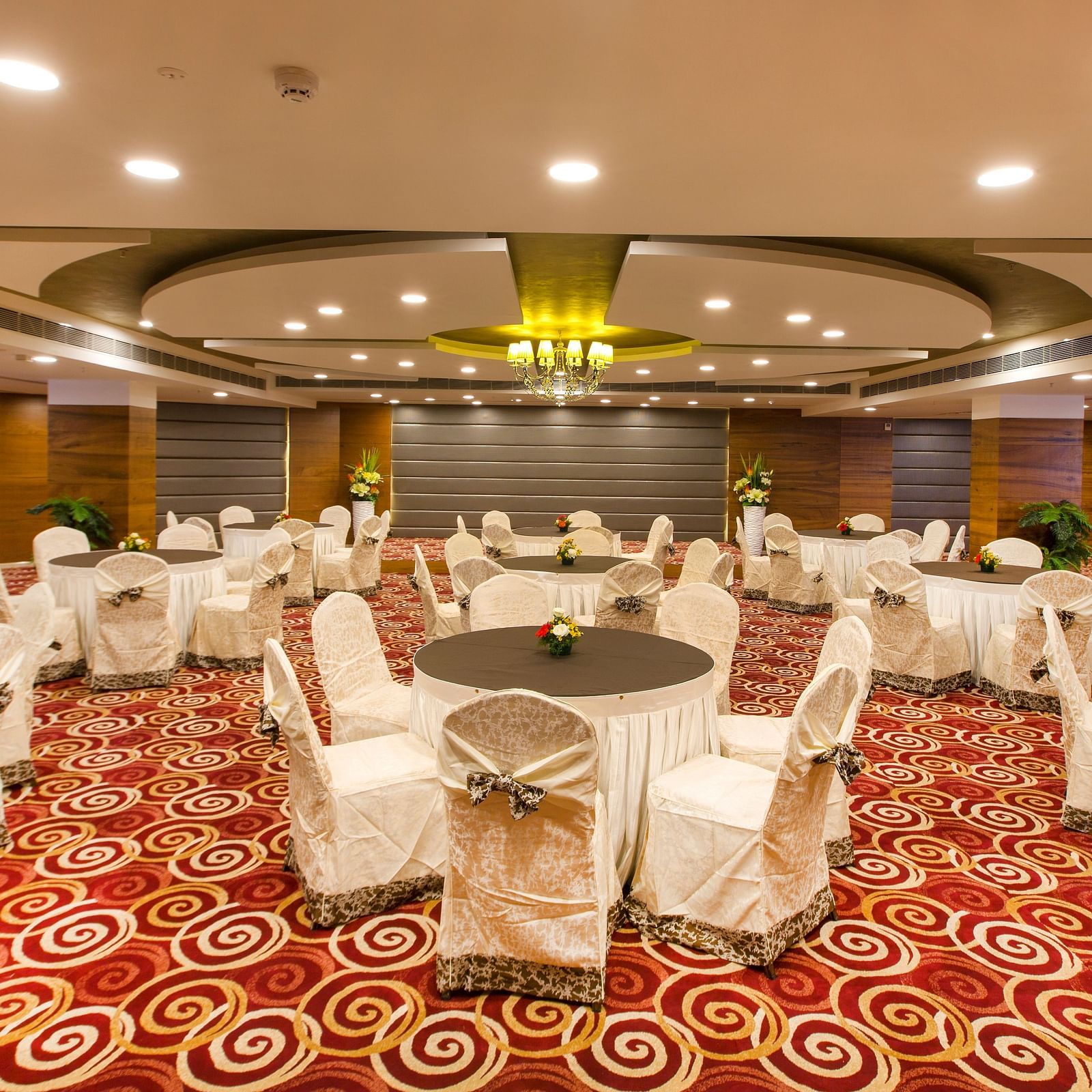 Round table seating arrangements inside Orion Hall Hotel Pai Viceroy Tirupathi 