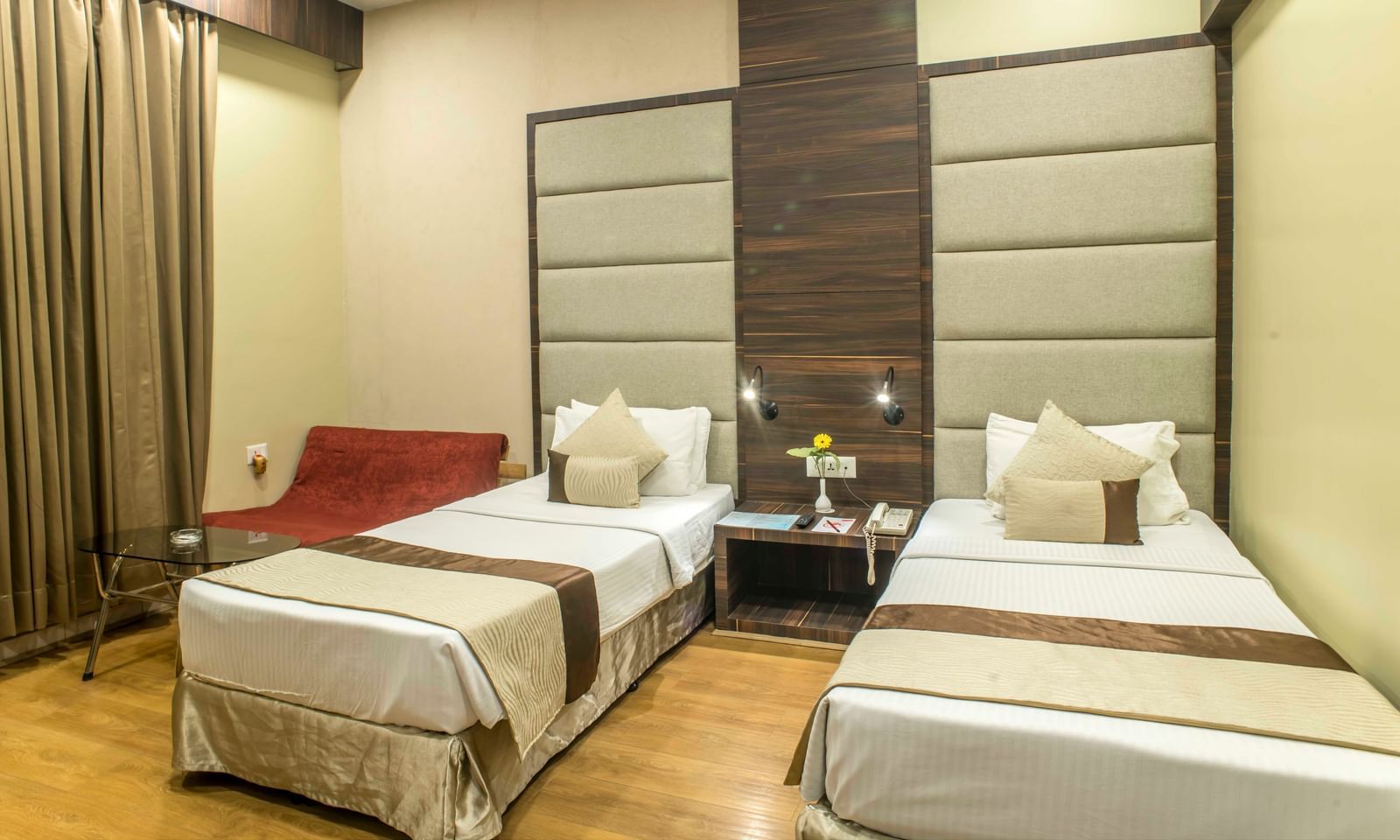 Comfortable hotel room with two single beds, warm lighting, and simple decor| The Citi Residenci Hotel Durgapur