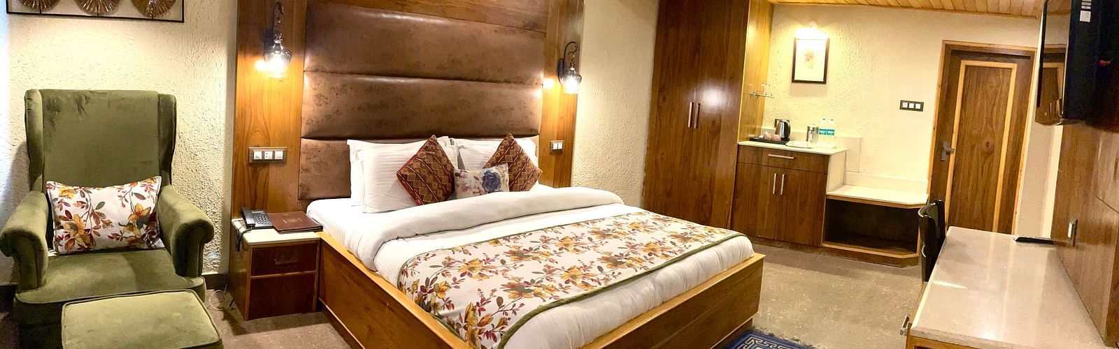A bedroom with a plush bed, chair, and other