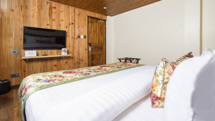 Side view of Suite With Balcony room with TV mounted on the wall at Mount Lungta Boutique Hotel & Spa