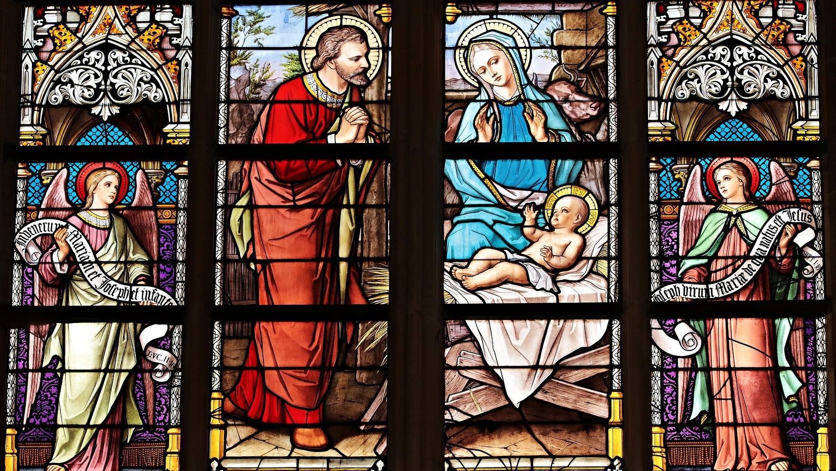 Coloured windows showing the birth of Jesus Christ