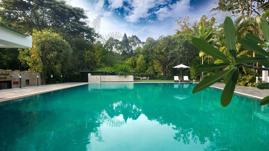 Outdoor swimming pool surrounded by trees-Amanvana Spa Resort, Coorg - Luxury Resort