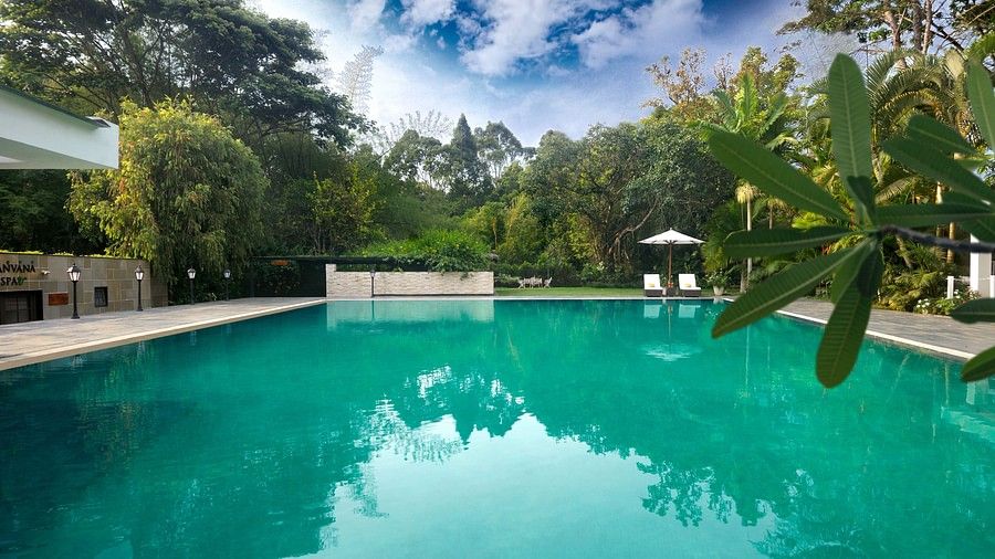 Outdoor swimming pool surrounded by trees-Amanvana Spa Resort, Coorg - Luxury Resort
