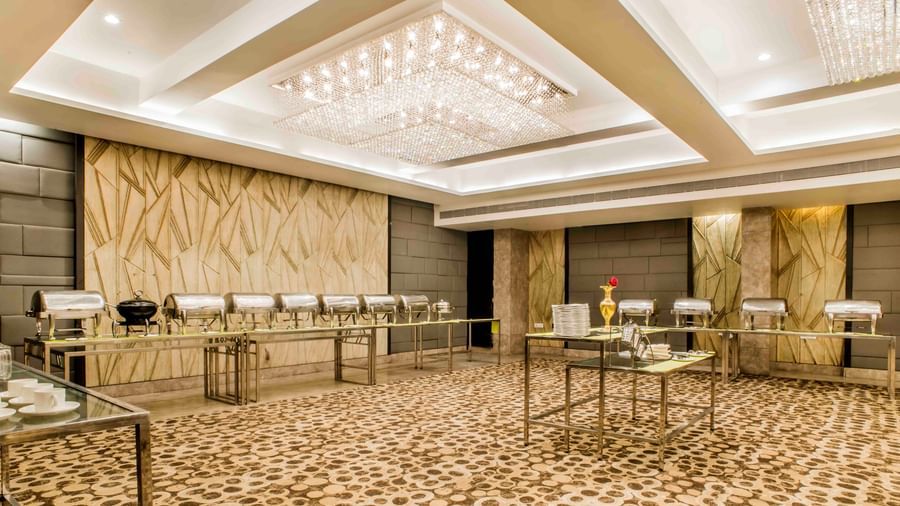 A buffet setup and additional seating in a spacious hall at The Citi Residenci Hotel, Durgapur.