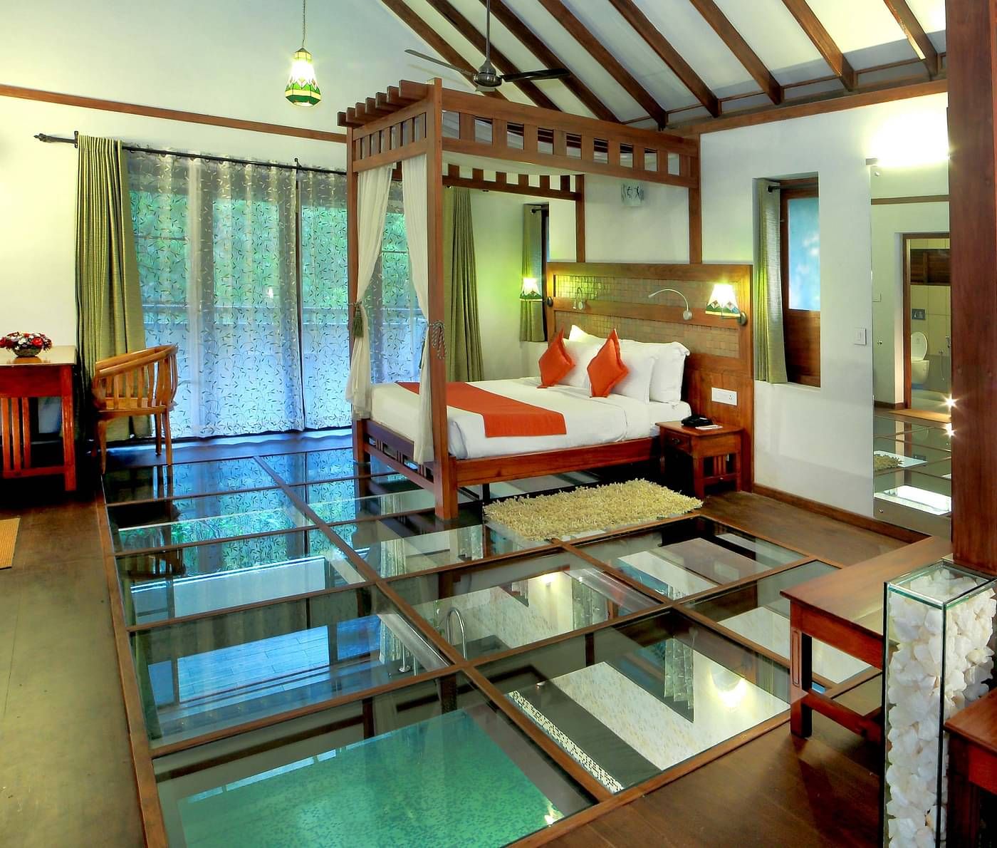 Room with a double bed and glass floor at Vythiri Resort, Wayanad