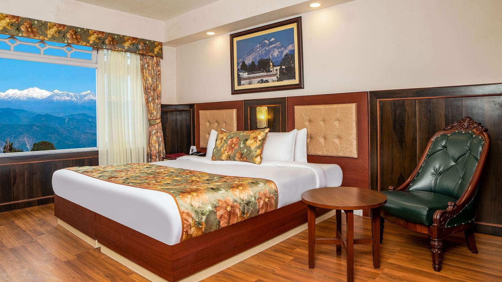 A bed, chair, and a coffee table in a room that has a glass window | Summit Oakden Resort & Spa, Mall Road