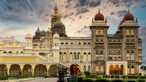 Facade of Mysore Palace with its towering dome-like structures under a vibrat sky