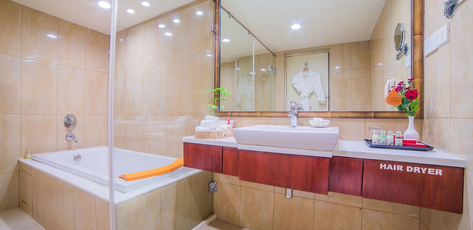An elegant hotel bathroom featuring a bathtub, modern fixtures, and marble accents A grand hotel suite with an opulent red and white decor, large bed, and seating area, reflecting a traditional style at Sitara Luxury Hotel in Hyderabad near Ramoji Film Cit