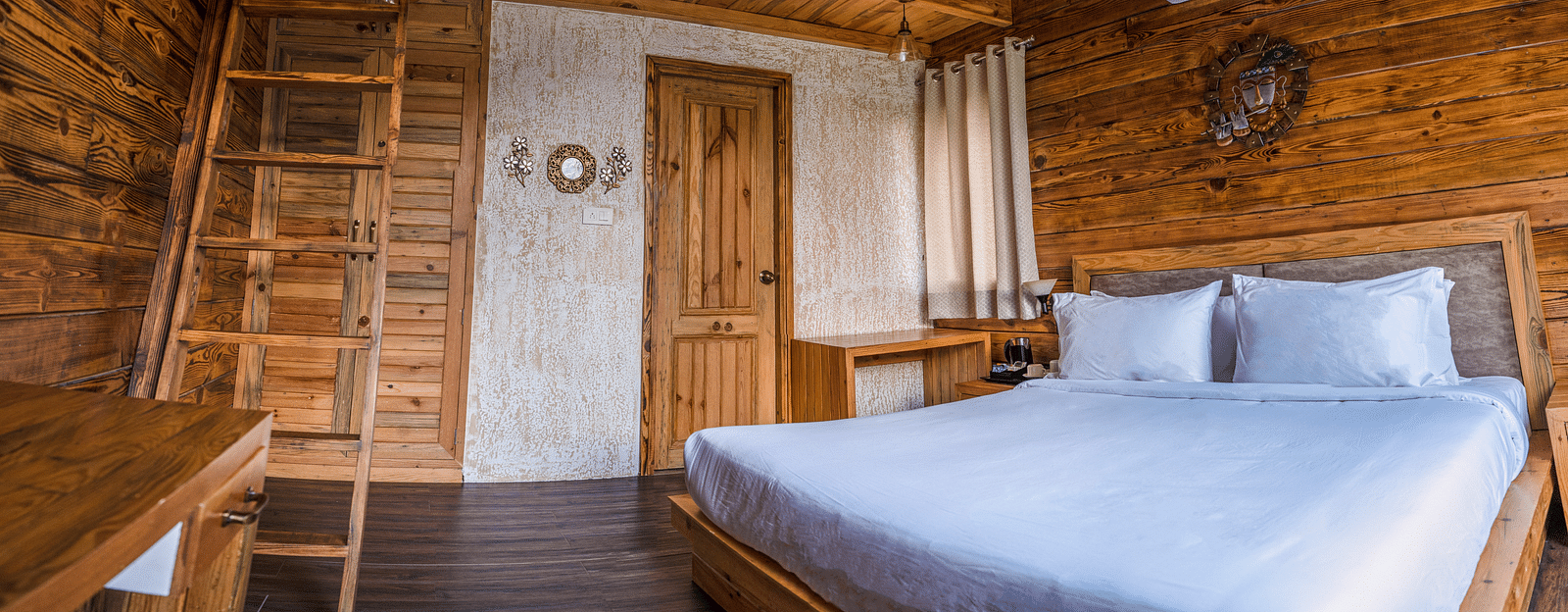 A view of the large bed at Pinewood Cottage at the Sylvan Retreat, Dehradun.