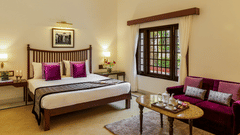 Palace Room featuring plush bed and sofa along with tea poy