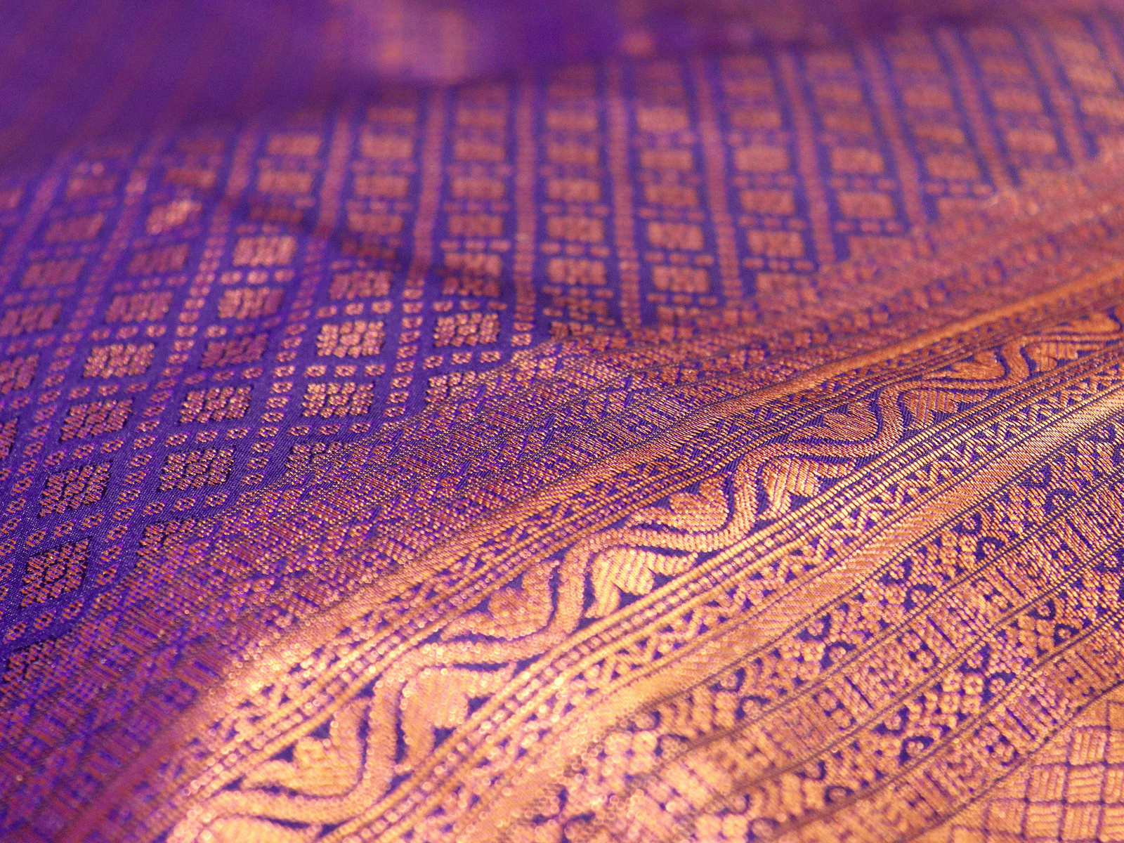 A saree with an intricate pattern on the body and the border.