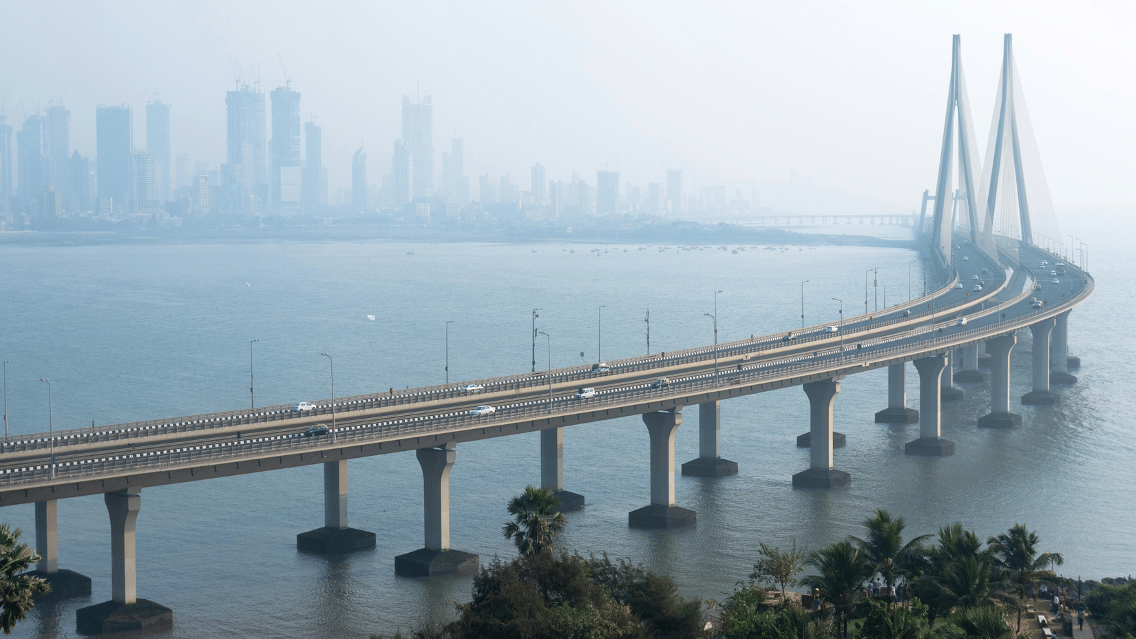An aerial view of the Worli-Bandra sea link bridge over the Arabian Sea with numerous high rises seen in the distance. A Mumbai-to-Chennai trip takes about 2 hours by flight.