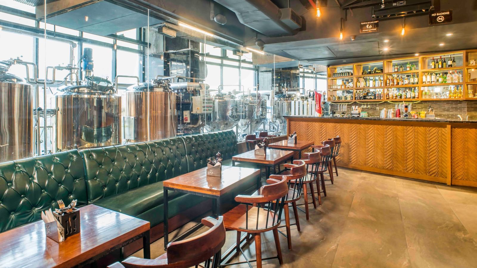 The interior of a bar or restaurant with seating at The Citi Residenci Hotel, Durgapur.