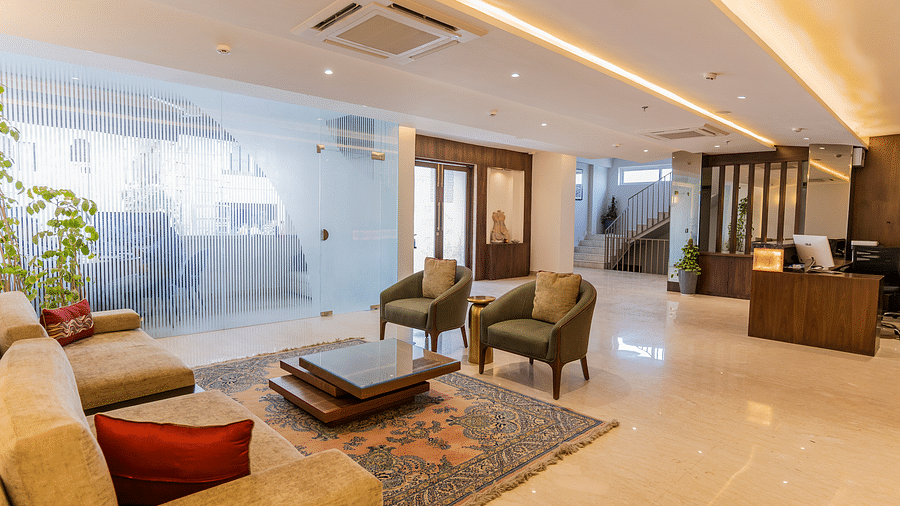lobby featuring modern furnishings, including comfortable seating, a glass coffee table, and a front desk of Aura Boutique Hotel, Udaipur