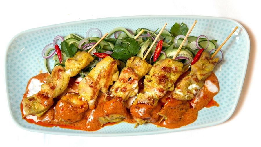 image of a dish called as chicken satay in gai peanut sauce served at the pickwick multi cuisine restaurant