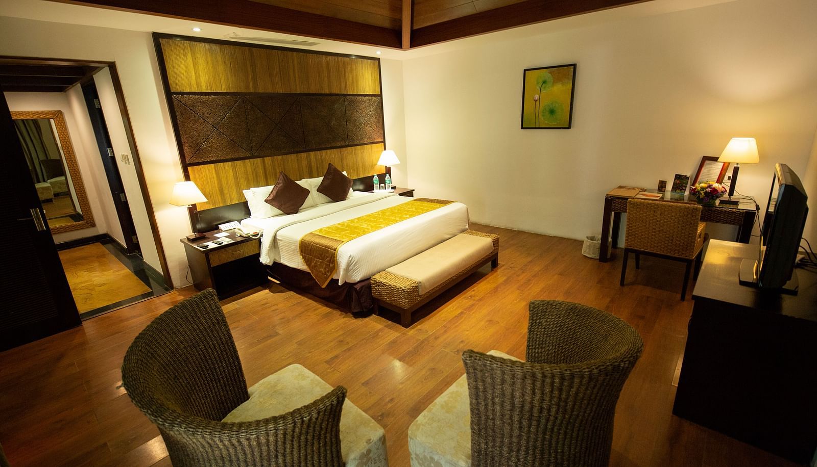 GUADALOUPE Luxury Villa bedroom wth a king sized bed and a couple of seats at Ocean Spray Puducherry