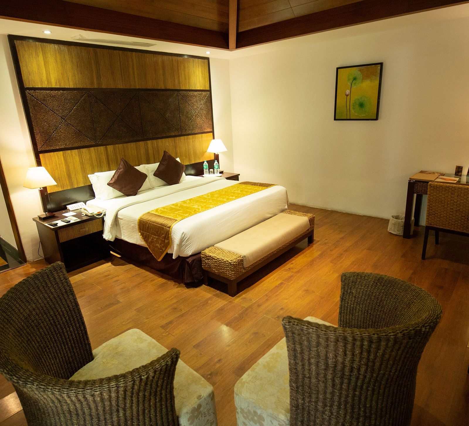 GUADALOUPE Luxury Villa bedroom wth a king sized bed and a couple of seats at Ocean Spray Puducherry