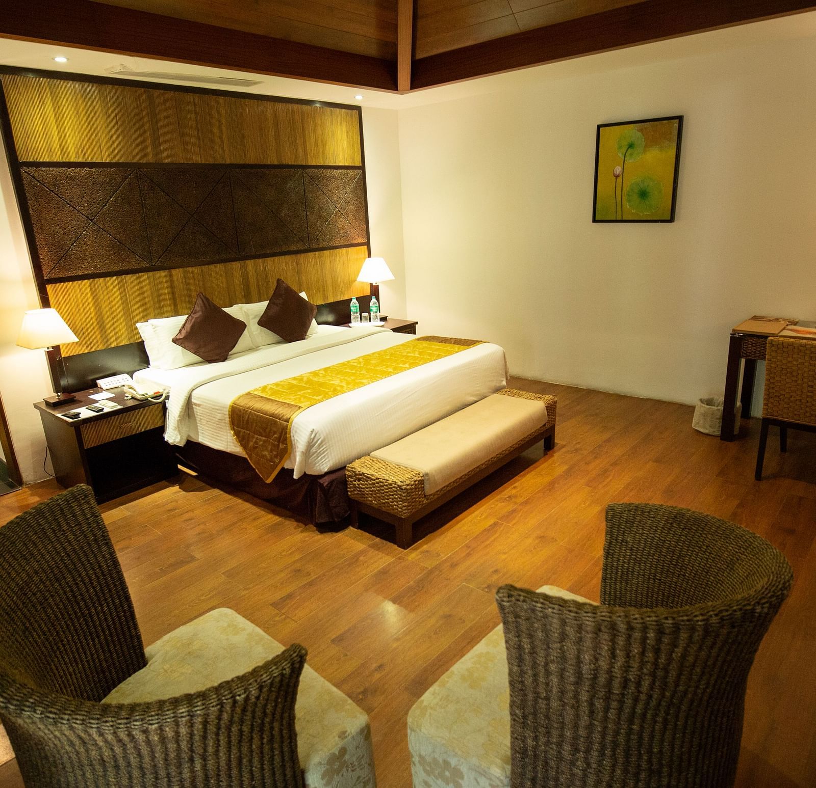 GUADALOUPE Luxury Villa bedroom wth a king sized bed and a couple of seats at Ocean Spray Puducherry
