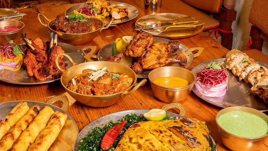 Image featuring a traditional Indian feast with assorted kebabs, curries, and tandoori delights