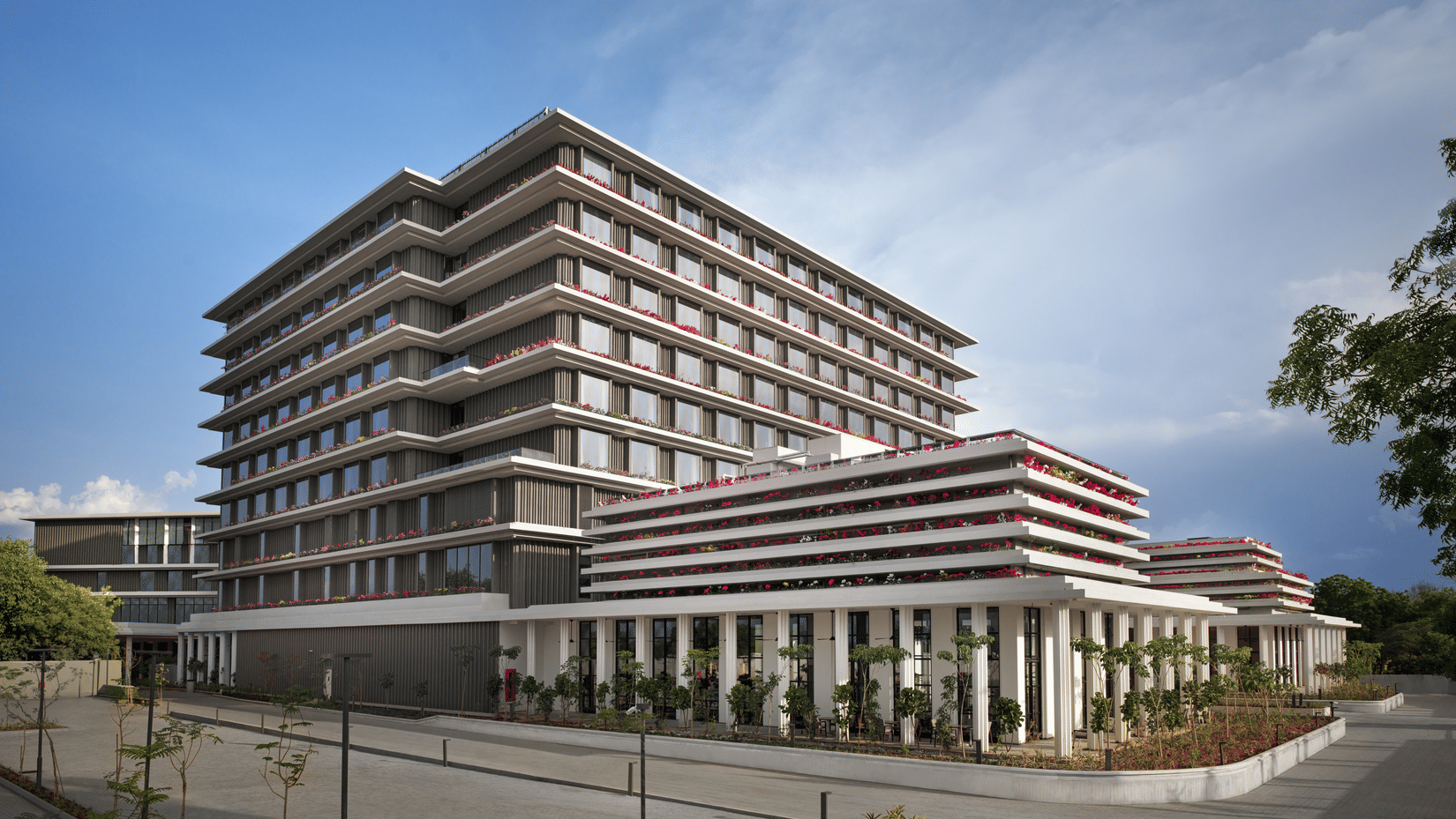 Multi storey hotel building exterior against a clear sky at The Residency Signature Madurai.