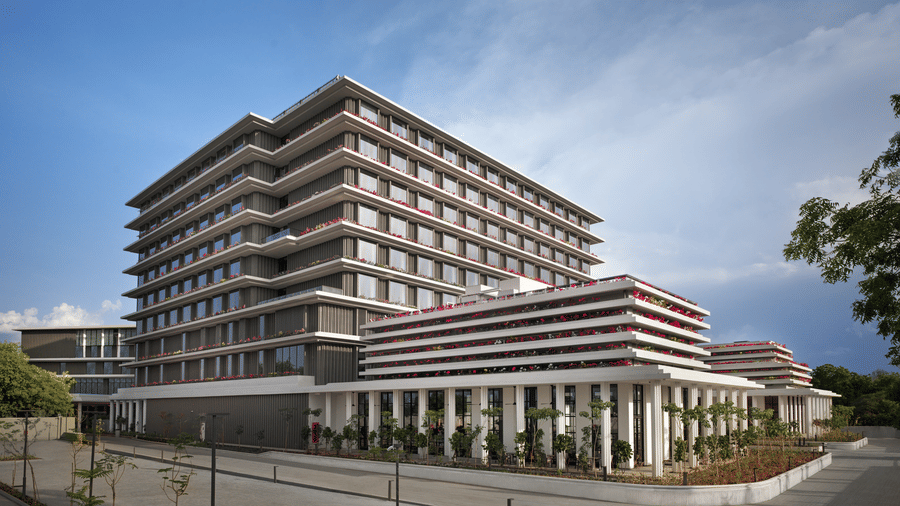 Multi storey hotel building exterior against a clear sky at The Residency Signature Madurai.
