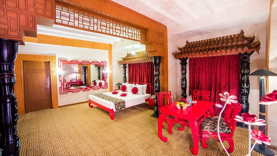 A luxurious red and white themed hotel suite with traditional furnishings and a festive atmosphere at Sitara Luxury Hotel in Hyderabad near Ramoji Film City.