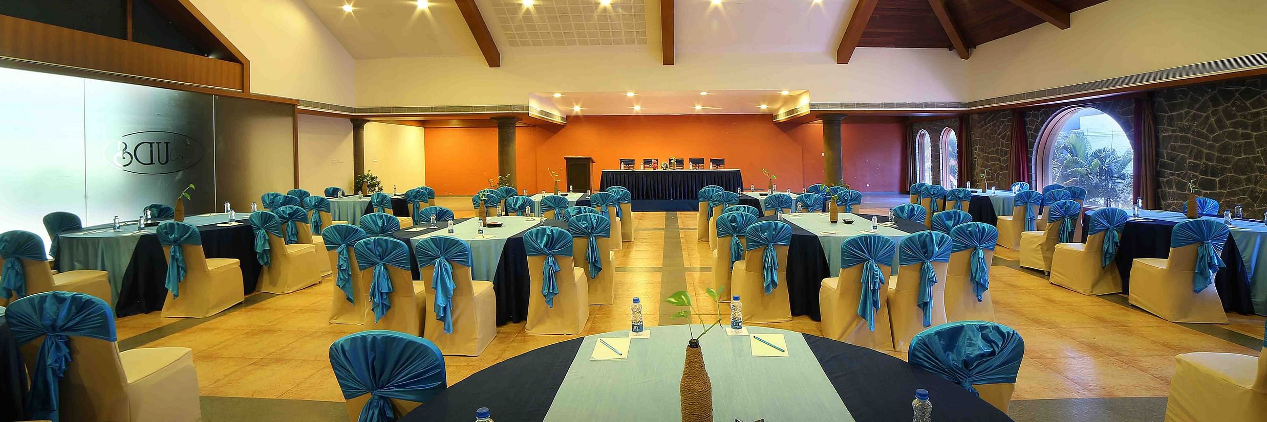 A large and beautifully designed banquet hall with warm lighting, stylish decor, and comfortable seating arranged neatly across the space at Uday Samudra Leisure Beach Hotel