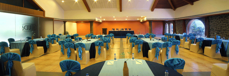 A large and beautifully designed banquet hall with warm lighting, stylish decor, and comfortable seating arranged neatly across the space at Uday Samudra Leisure Beach Hotel