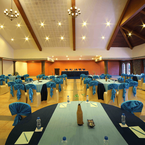 A large and beautifully designed banquet hall with warm lighting, stylish decor, and comfortable seating arranged neatly across the space at Uday Samudra Leisure Beach Hotel