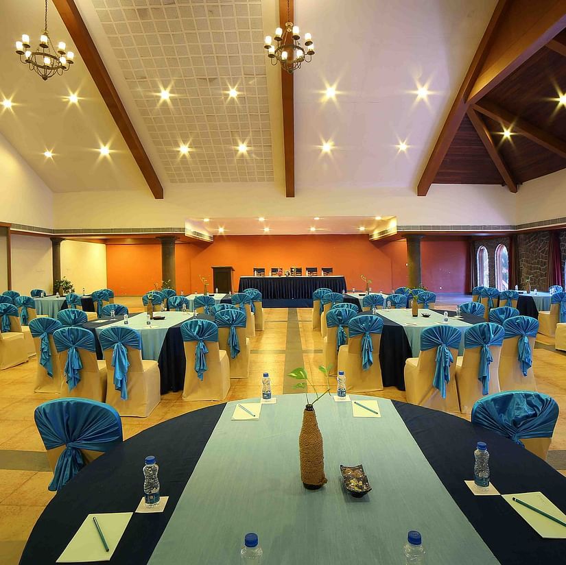 An image of a large and beautifully designed banquet hall with warm lighting, stylish decor, and comfortable seating arranged neatly across the space - Uday Samudra Leisure Beach Hotel