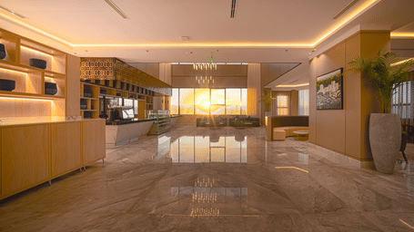 Grand Iva Cafe seen with ambient lighting, modern decor, and natural lighting entering through a large glass window.