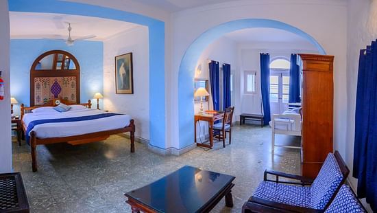 Hill Fort Kesroli 14th Century Alwar - interior view of the Sitara Mahal - Countryside View  featuring a king size bed, a coffee table and blue decor