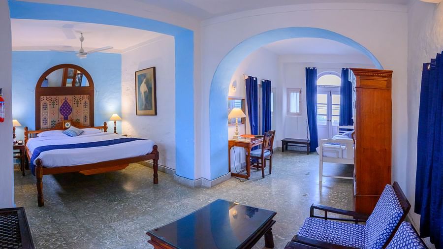 Hill Fort Kesroli 14th Century Alwar - interior view of the Sitara Mahal - Countryside View  featuring a king size bed, a coffee table and blue decor
