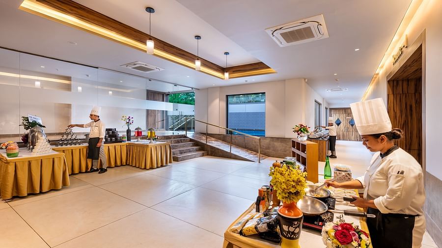 Buffet setup at the Golden Tulip, Candolim, Goa, with chefs preparing fresh dishes in an open dining space.